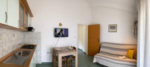 a kitchen with a sink and a couch in a room at The Ana Apartments in Komiža