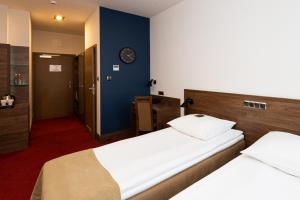 Postel nebo postele na pokoji v ubytování Hotel Olimp Business & Spa
