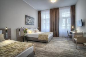 Posteľ alebo postele v izbe v ubytovaní Hotel Páv