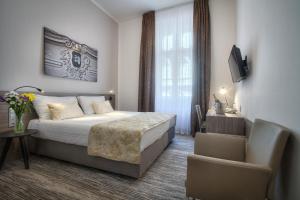Posteľ alebo postele v izbe v ubytovaní Hotel Páv