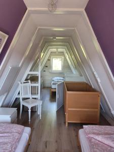 a attic room with a bed and a desk at Ferienhaus am Helenesee 5 in Frankfurt Oder