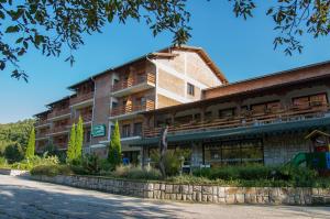 a large building with a stone wall in front of it at Tourist center Momina Krepost in Veliko Tŭrnovo