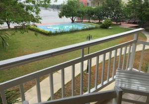 a view of a swimming pool from a balcony at Baan Talay See Cream Resort in Samut Songkhram