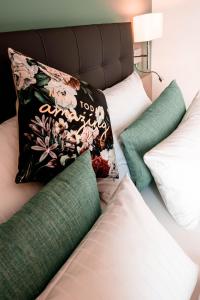 a bed with two pillows on top of it at Zeitlos Boutiquehotel in Limburg an der Lahn