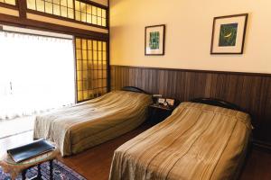 
Tempat tidur dalam kamar di Hotel Hanakoyado
