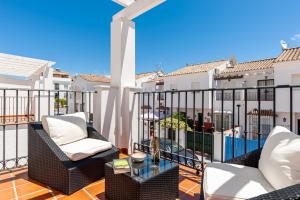 a balcony with two chairs and a table at Home Vejer in Vejer de la Frontera