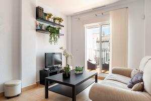 a living room with a couch and a tv at Home Vejer in Vejer de la Frontera