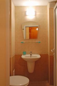 a bathroom with a sink and a toilet and a mirror at Tourist center Momina Krepost in Veliko Tŭrnovo