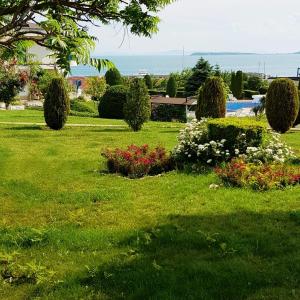 a park with flowers and bushes in the grass at Riviera Complex 6 in Sveti Vlas