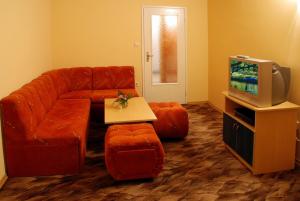 a living room with a couch and a tv at Tourist center Momina Krepost in Veliko Tŭrnovo +28 photos