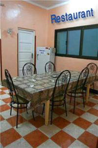 a table and chairs in a room with a refrigerator at Fontana Luxor Hostel in Luxor