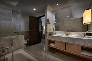 a bathroom with a sink, toilet and bathtub at Berjaya Times Square Hotel, Kuala Lumpur in Kuala Lumpur