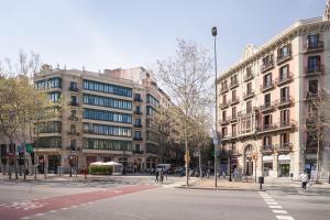 a city street with buildings and people walking on the street at Art House Granvia in Barcelona
