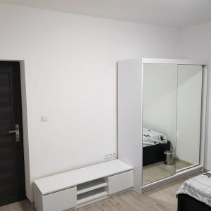 a white room with a mirror and a bed at MirrorRoom PL Downtown in Warsaw