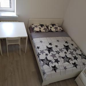 a small bedroom with a bed and a table at MirrorRoom PL Downtown in Warsaw