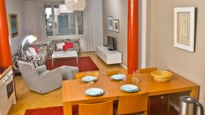 a dining room and living room with a table and chairs at Helsinki Apartments in Helsinki