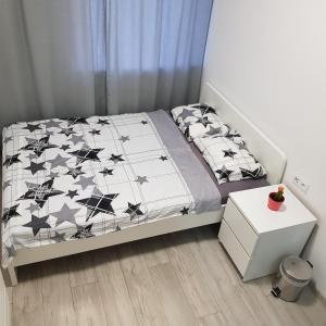 a bedroom with a bed with a black and white comforter at MirrorRoom PL Downtown in Warsaw