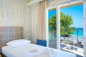 a bedroom with a bed and a view of the ocean at Iliorama Luxury Apartments in Skala Potamias