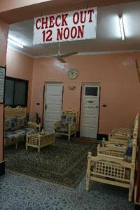 a room with chairs and a sign that reads check out moon at Fontana Luxor Hostel in Luxor