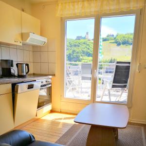 a kitchen with a table in front of a window at Bernkasteler Moselapartments in Bernkastel-Kues