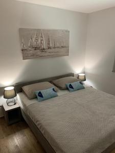 a bedroom with a bed with two pillows on it at Apartmani Tisno TM in Tisno