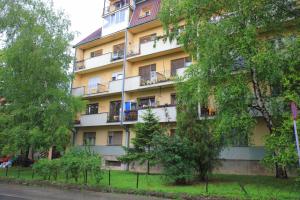 an apartment building with balconies on the side of it at Apartman Tina Sokobanja in Soko Banja