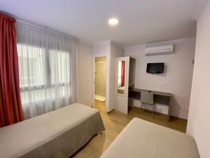 Postel nebo postele na pokoji v ubytování Hostal Pensimar