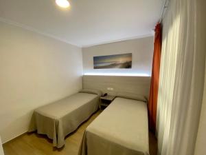 Postel nebo postele na pokoji v ubytování Hostal Pensimar