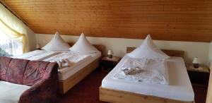 a bedroom with two beds with pillows on them at Pension Gerlach in Seiffen