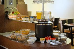a bar with a buffet of food and drinks at Best Western Dam Square Inn in Amsterdam