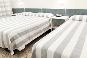 Postel nebo postele na pokoji v ubytování Hotel Aurea