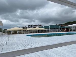 a large building with a swimming pool in front of it at Апартаменты Золотой Бугаз in Karolino-Buhaz