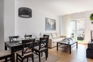 a living room with a table and a couch at Casa Ignacio in Vejer de la Frontera