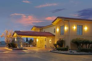 a house with a garage in a parking lot at La Quinta Inn by Wyndham Reno in Reno