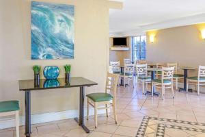 a restaurant with tables and chairs and a painting on the wall at La Quinta Inn by Wyndham Reno in Reno