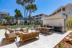 eine Terrasse mit Gartenmöbeln und einem Tisch vor einem Gebäude in der Unterkunft Villa Torrenova 36 in Magaluf