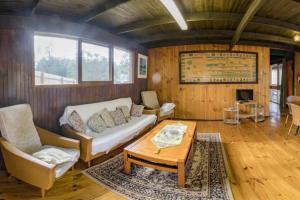 a living room with a couch and a table at Beachouse in Lock Sport +15 photos
