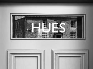 a sign on the door of a building with the word hos at Hues - Castle Cary in Castle Cary