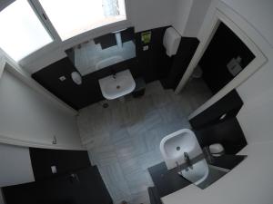an overhead view of a bathroom with a toilet and sink at Oasis Backpackers' Palace Seville in Seville