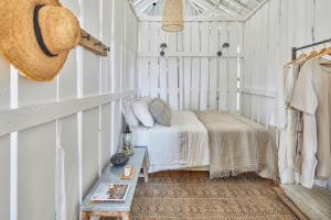 a bedroom with a bed and a table in it at Casa Branca do Olival in Alcácer do Sal