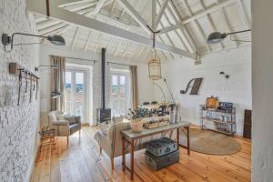 a living room with a table and chairs at Casa Branca do Olival in Alcácer do Sal