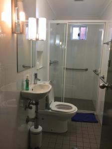 a bathroom with a shower and a toilet and a sink at Guesthouse 83 in Cronulla +70 photos