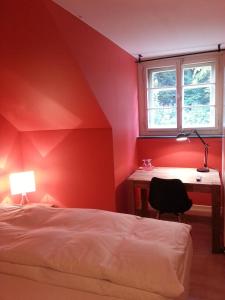 a bedroom with a bed and a desk and a window at Gasthof Bären Aarburg last Check in 2100 pm in Aarburg