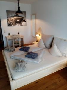 a white bed with towels on it in a room at Apartment Diana in Bad Goisern