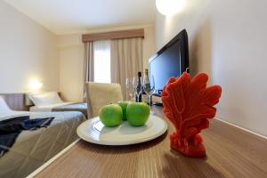 a table with a plate of fruit on it in a hotel room at Hotel Mirasole International in Gaeta