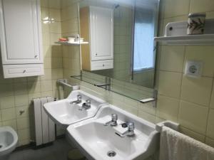 a bathroom with two sinks and a mirror at Calle Quinta, 3 in Luanco