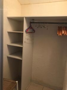 a walk in closet with a hanger and shelves at Mas de la Vieille Vigne in Argelès-sur-Mer