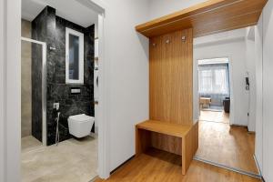 a bathroom with a toilet and a sink in a room at Nový designový apartmán s klimatizací in Rychnov nad Kněžnou