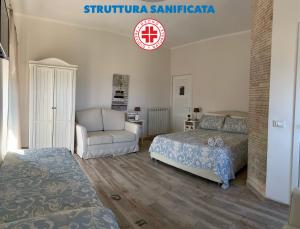 a bedroom with two beds and a chair at Don Giacchì Country House in Catanzaro Lido