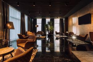 a lobby of a hotel with chairs and tables at Premium Park Hotel in Prizren